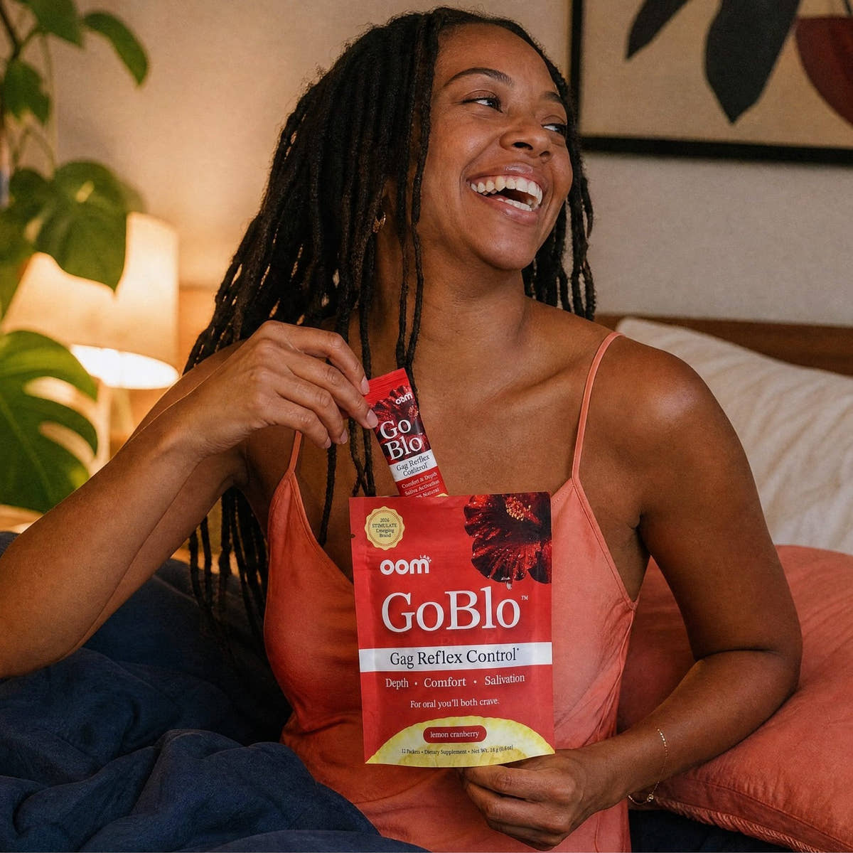 A laughing woman holding a GoBlo pouch.